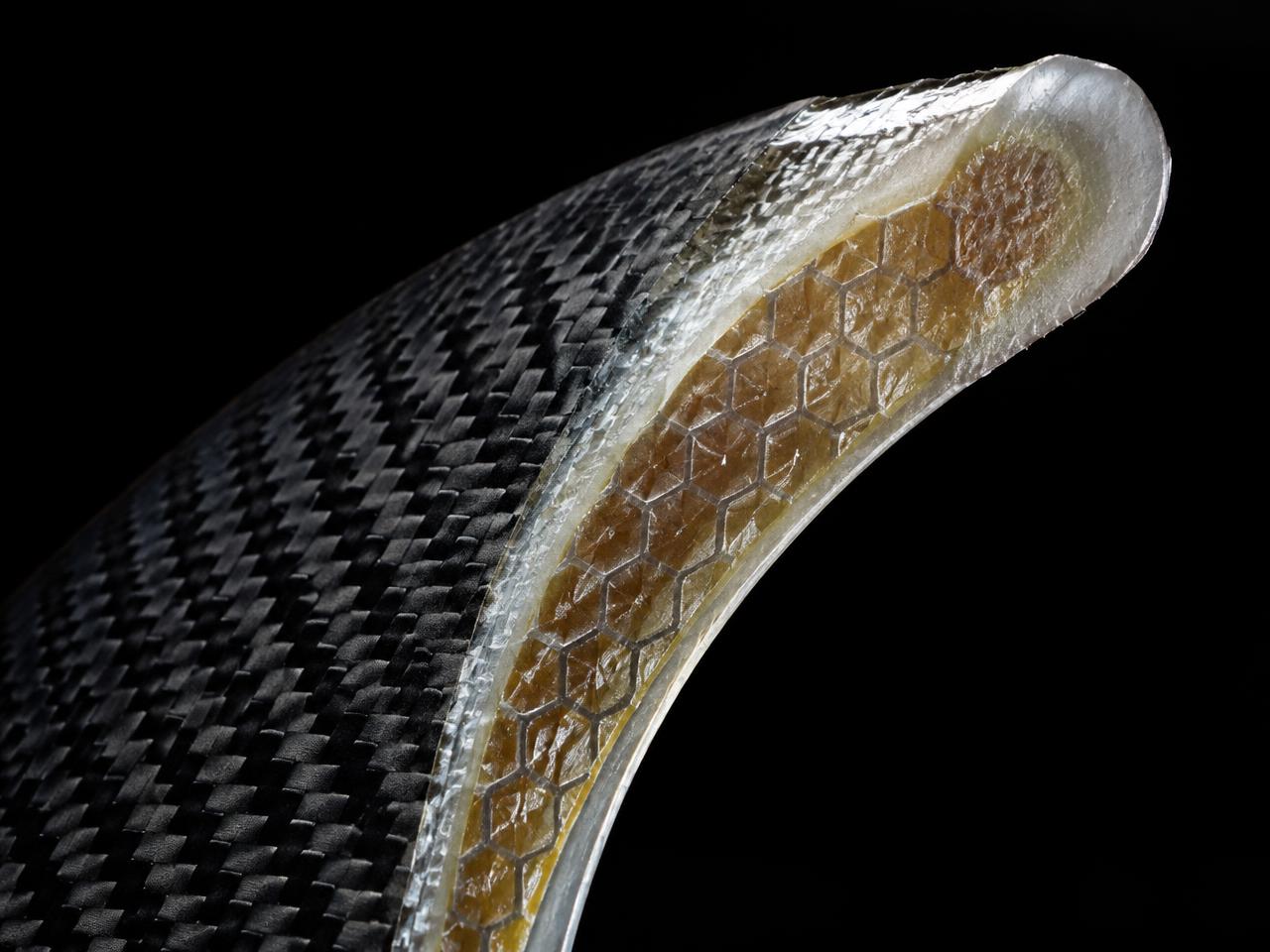 Cross-section of a fin showing carbon, honeycomb and glass layers